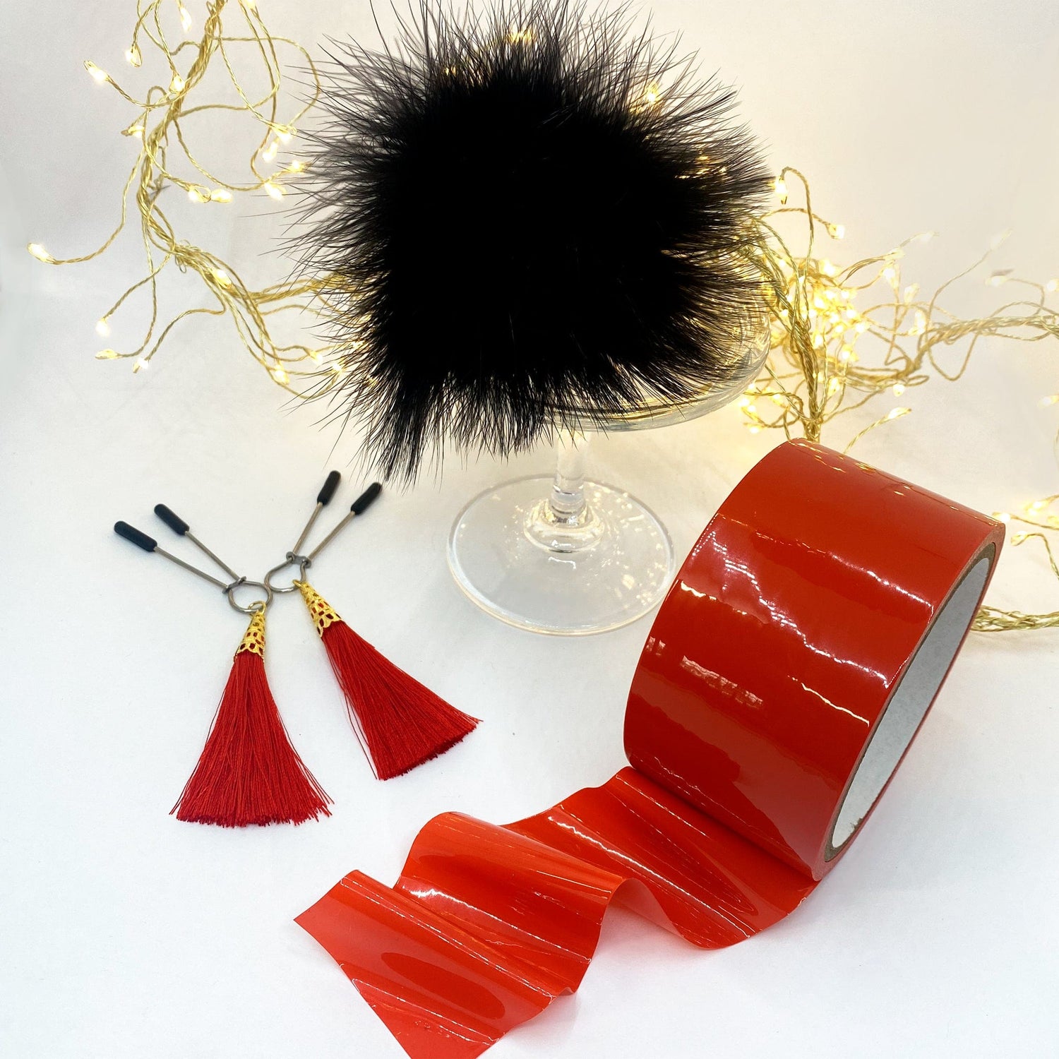 Bondage Accessories: bondage tape, tassle nipple clamps & black feather pom - Sh! Women's Store