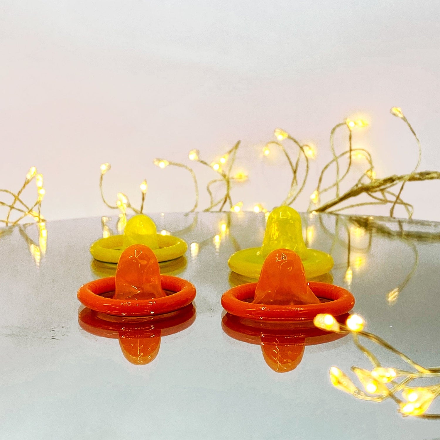 4 condoms orange & yellow open teats
