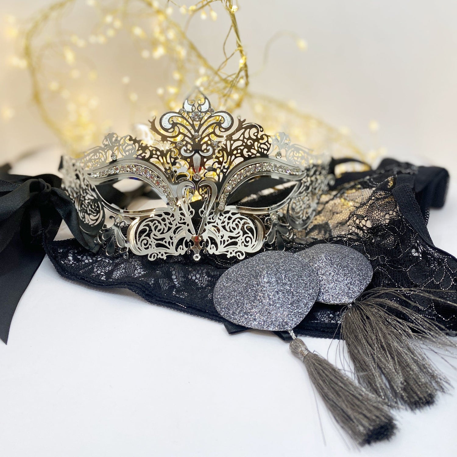 Lingerie collection; silver mask, silver nipple tassles, black stockings