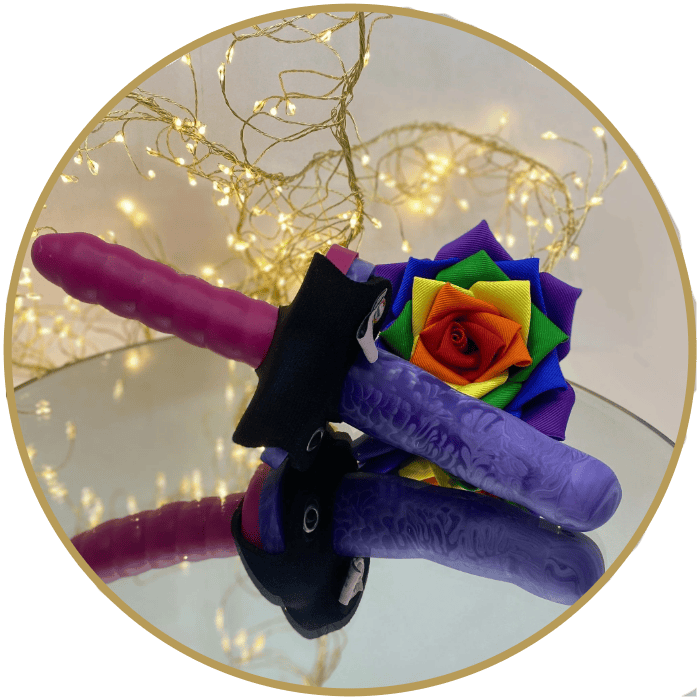A double dildo made up of pink Wirly 2 dildo & purple cupid 3 dildo connected together with a double dildo connector accesory