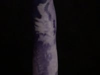 A video of the Cupid 3 dildo in white and purple marble silicone, against a black background. 