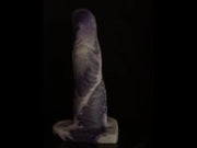 A video of the Cupid 6 dildo in white and purple marble silicone, against a black background. 