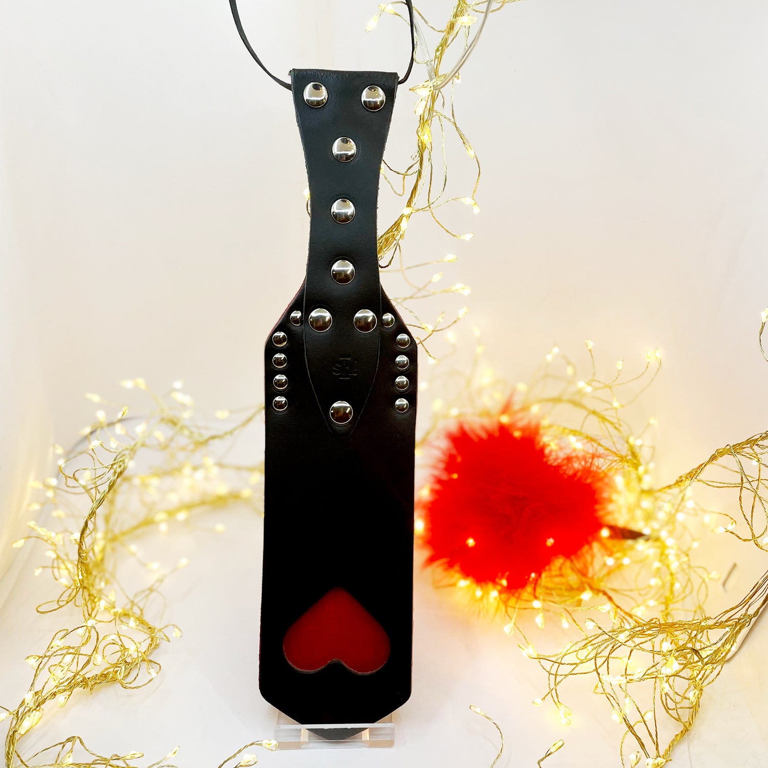 Spanking Paddle with red heart cut-out and red feather tickler
