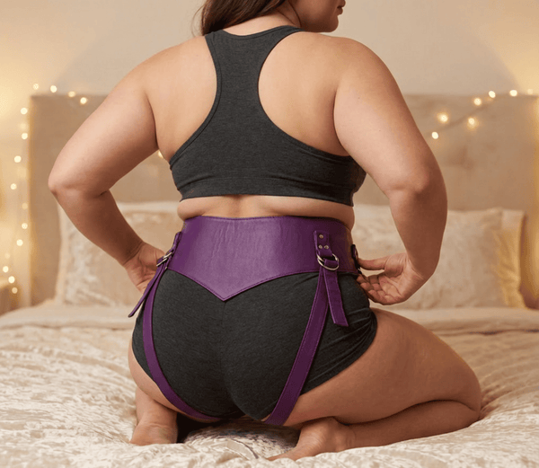 Super StrapOn Dildo Harness in purple leather worn on a model