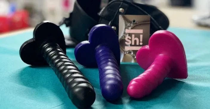 selection of different size ribbed silicone dildos for anal play on blue counter