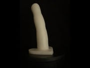 A video of the Cupid 3 dildo in white  silicone, against a black background. 